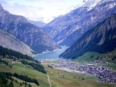 Italy, Province of Sondrio, Livigno, Aerial view of illuminated town in  Italian Alps at dusk stock photo