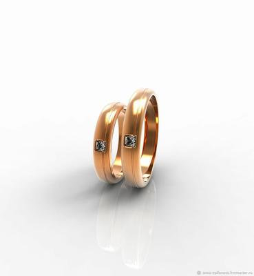 Свадебные кольца из золота с камнями и гравировкой образа любви