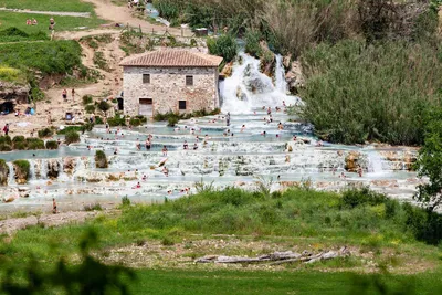 Toscane Italy, natural spa with waterfalls and hot springs at Saturnia  thermal baths, Grosseto, Tuscany, Italy aerial view on the Natural thermal  waterfalls couple at vacation at Saturnia Toscany Stock Photo |