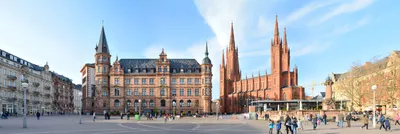 A Poster of Wiesbaden Germany Skyline - A River With Trees And Buildings In  The Background by HEBSTREIT